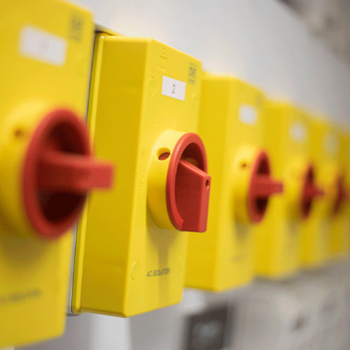 Line of yellow switches on a wall