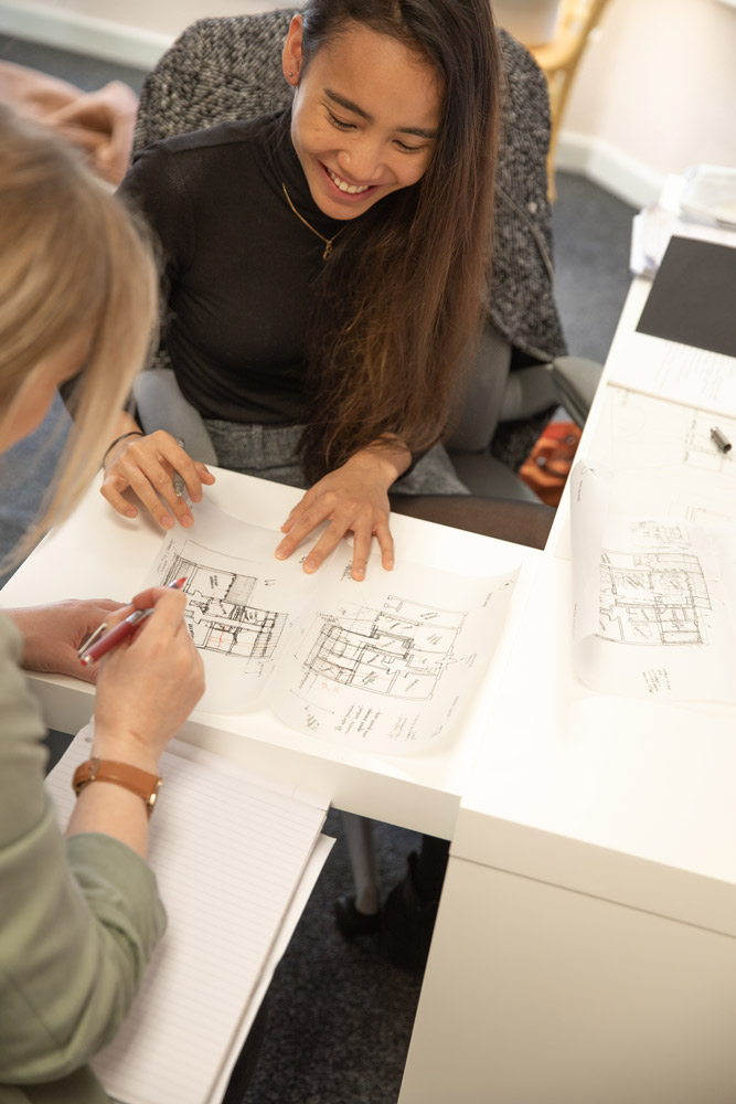 Two women planning and sketching a home