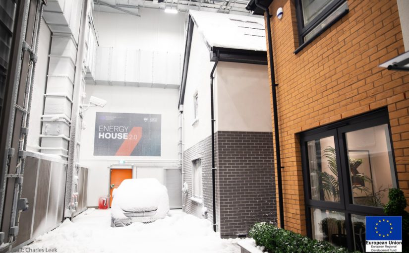Two detached houses built within chamber 1, with snow, of Energy House 2.0, University of Salford
