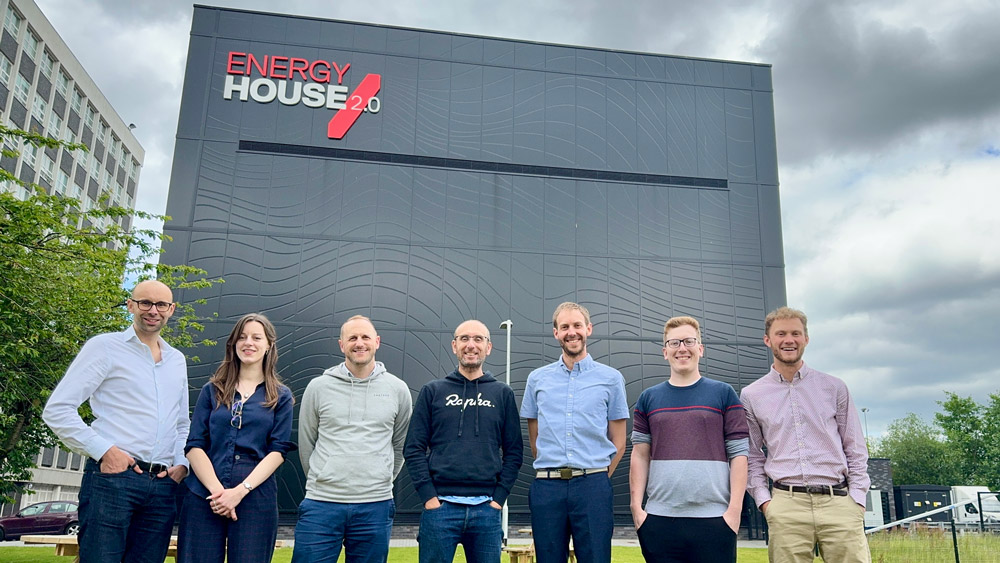 Work colleagues from Nusku standing outside Energy House 2.0 building at the University of Salford